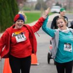 Two runners high five at 401K Race event