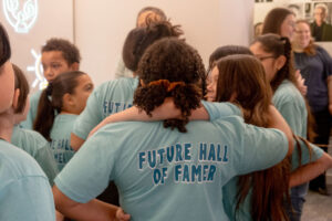 A group of young students hugging