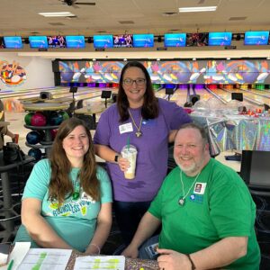 Three event participants at a bowling alley