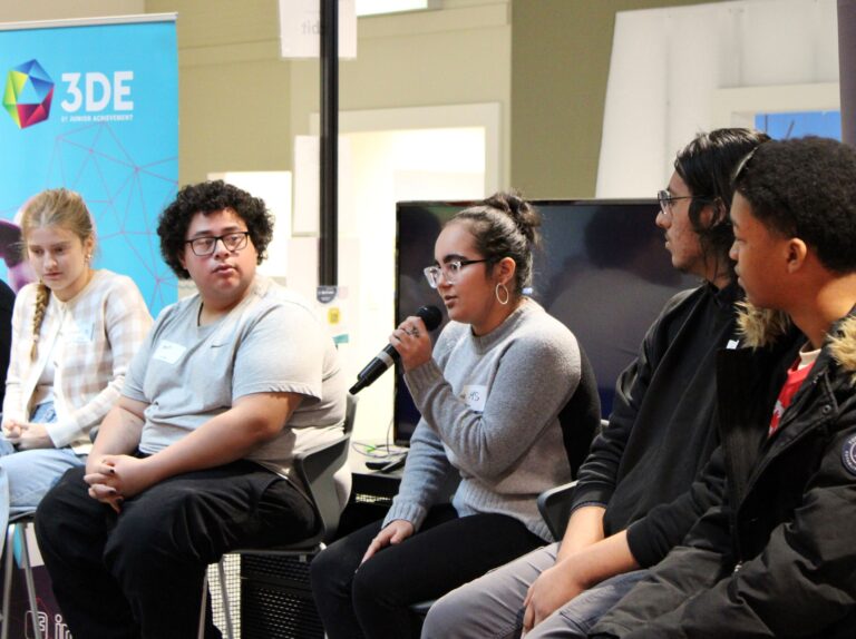 3DE Student Panel with five high school students, one with a microphone