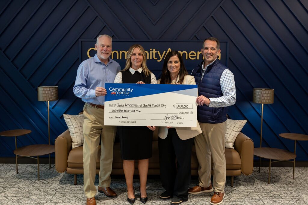 A group of people holding a big check at a check presentation