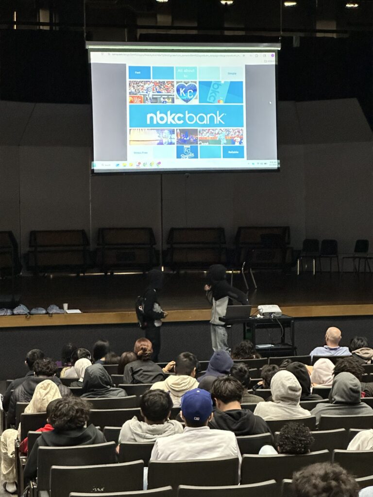 Group of students presenting in an auditorium 