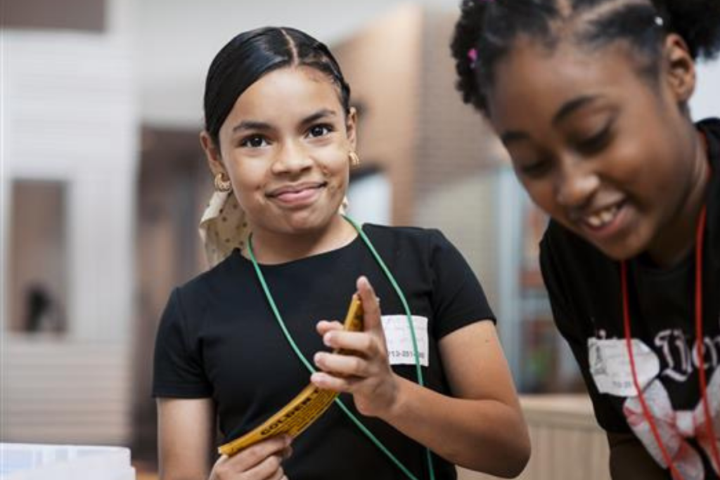 A young student smiling at the camera
