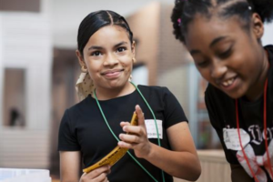 A young student smiling at the camera